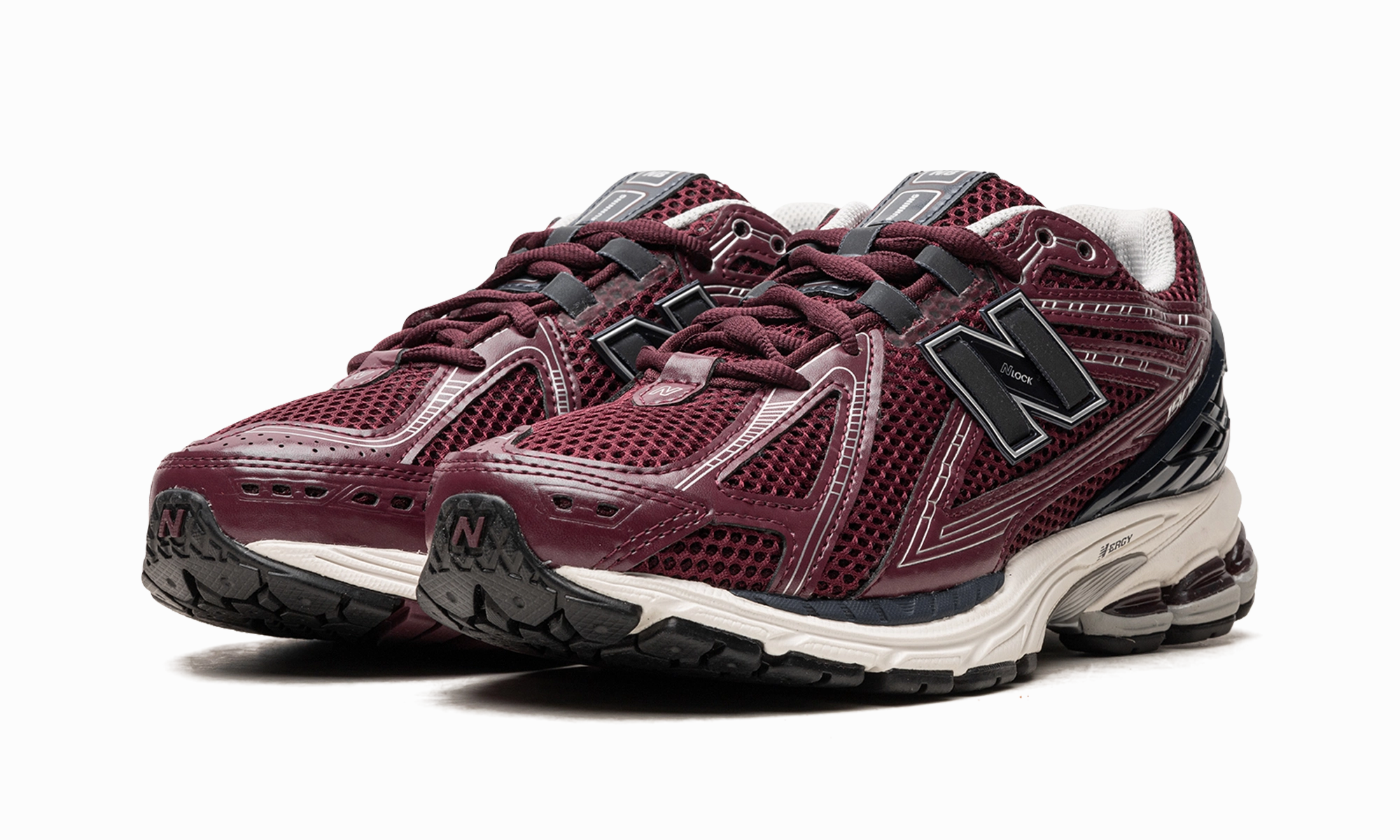 1906R "Burgundy Black" running in a city park shoes