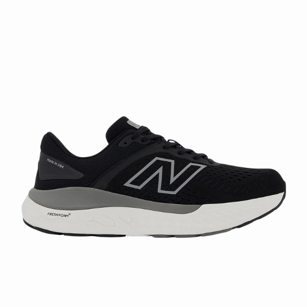 New Balance Women's Fresh Foam X 1540v4 Wide Black/White running in a kelp forest area shoes Light - up